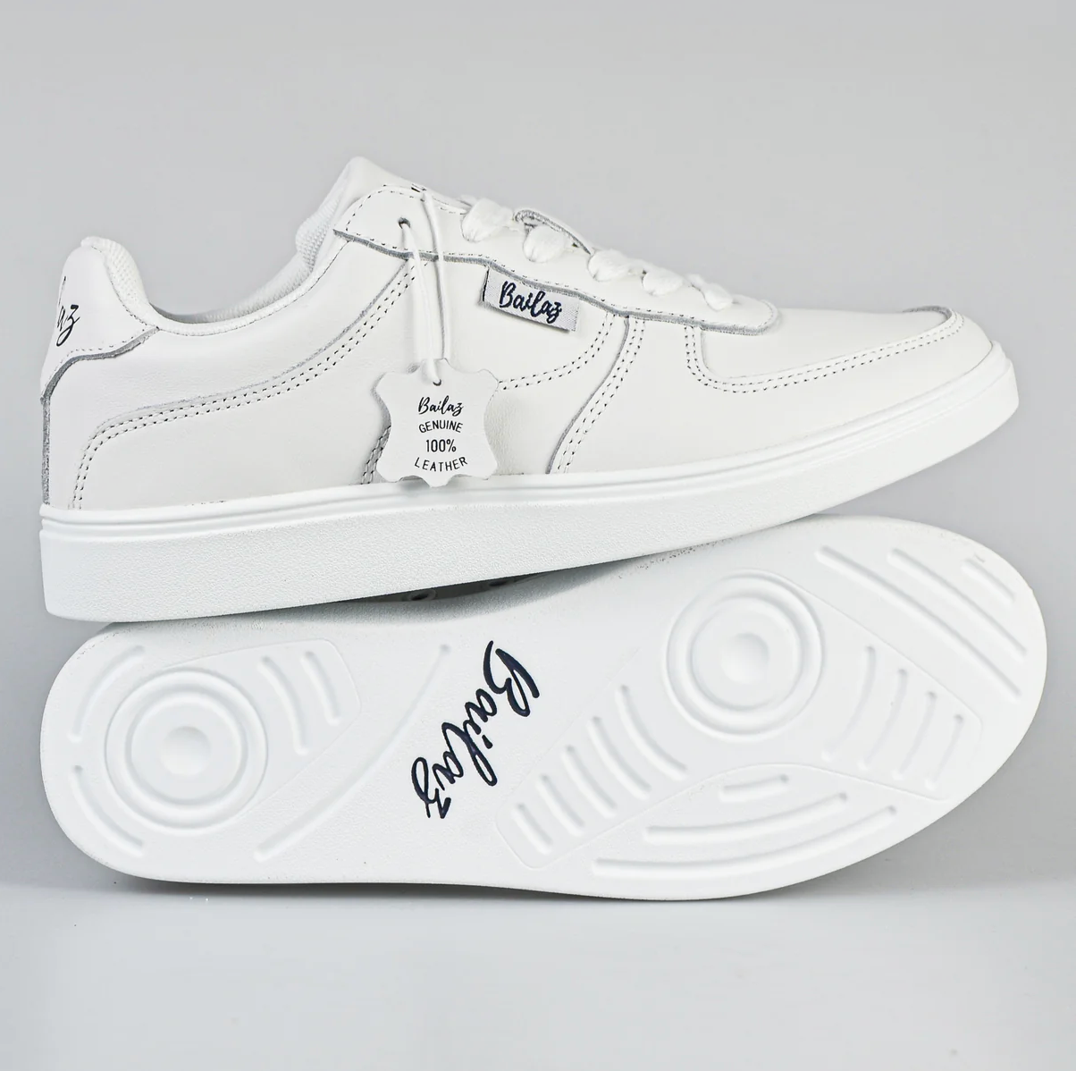 Close-up of a white dance shoes with the brand name 'Bailaz' on the lace tag, featuring a genuine leather upper and a proprietary polyurethane composite outsole